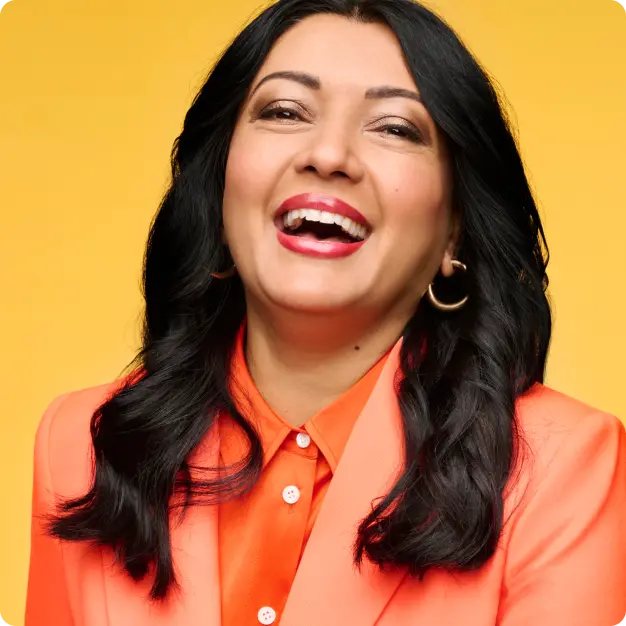 Woman in orange suit smiling